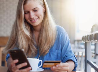 Girl with a debit card for payment